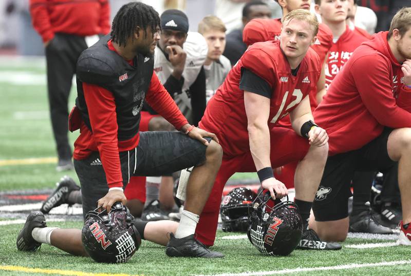 Northern Illinois University quarterback Rocky Lombardi talks to defensive end Michael Kennedy during a break in the action Wednesday, March 30, 2022, at spring practice in the Chessick Practice Center at NIU in DeKalb.