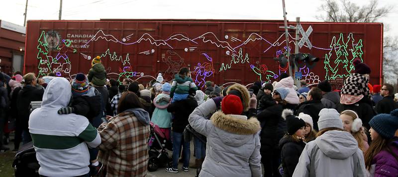 People watch the Canadian Pacific Kansas City Railway 2024 Holiday Train on Wednesday Nov. 27, 2024,  as the train pulls into Pingree Grove. The holiday train raised food and monetary donations for the D300 Food Pantry during its stop in Pingree Grove.