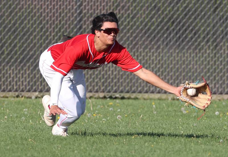 Naperville Central's Roan Orlanes dives but fields the ball on a bounce during their game against DeKalb Tuesday, April 30, 2024, at DeKalb High School.