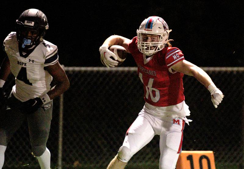 Marian Central’s Jacob Sievert celebrates after hauling in a reception against Chicago Hope in varsity football at Woodstock Friday night.