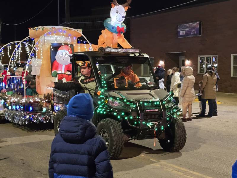 A float of Christmas inflatables participates Saturday, Dec. 7, 2024, in the Holiday Magic Lighted Santa Parade in Marseilles.