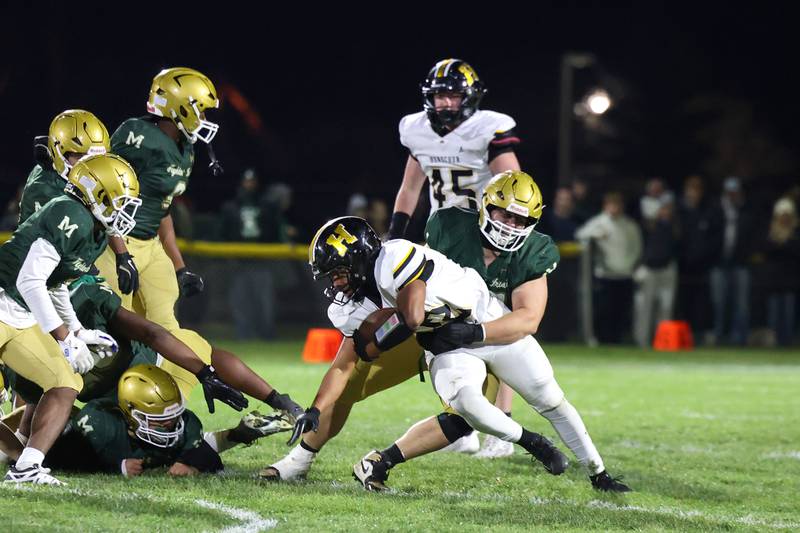 Bishop McNamara's Kian Bramer takes down Herscher's Alek Draper during Bishop McNamara's 38-14 victory in the IHSA Class 3A first round playoff game on Friday, Oct. 31, 2025.