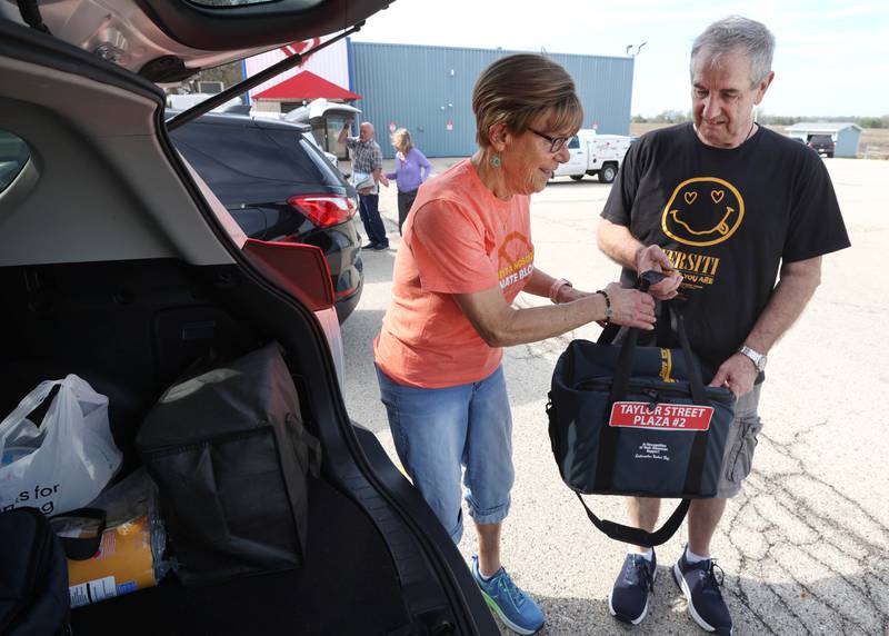 Volunteers Julie and John Ahlbach load up their van Friday, April 17, 2026, to deliver food to local residents as part of the Voluntary Action Center’s Meals on Wheels program.