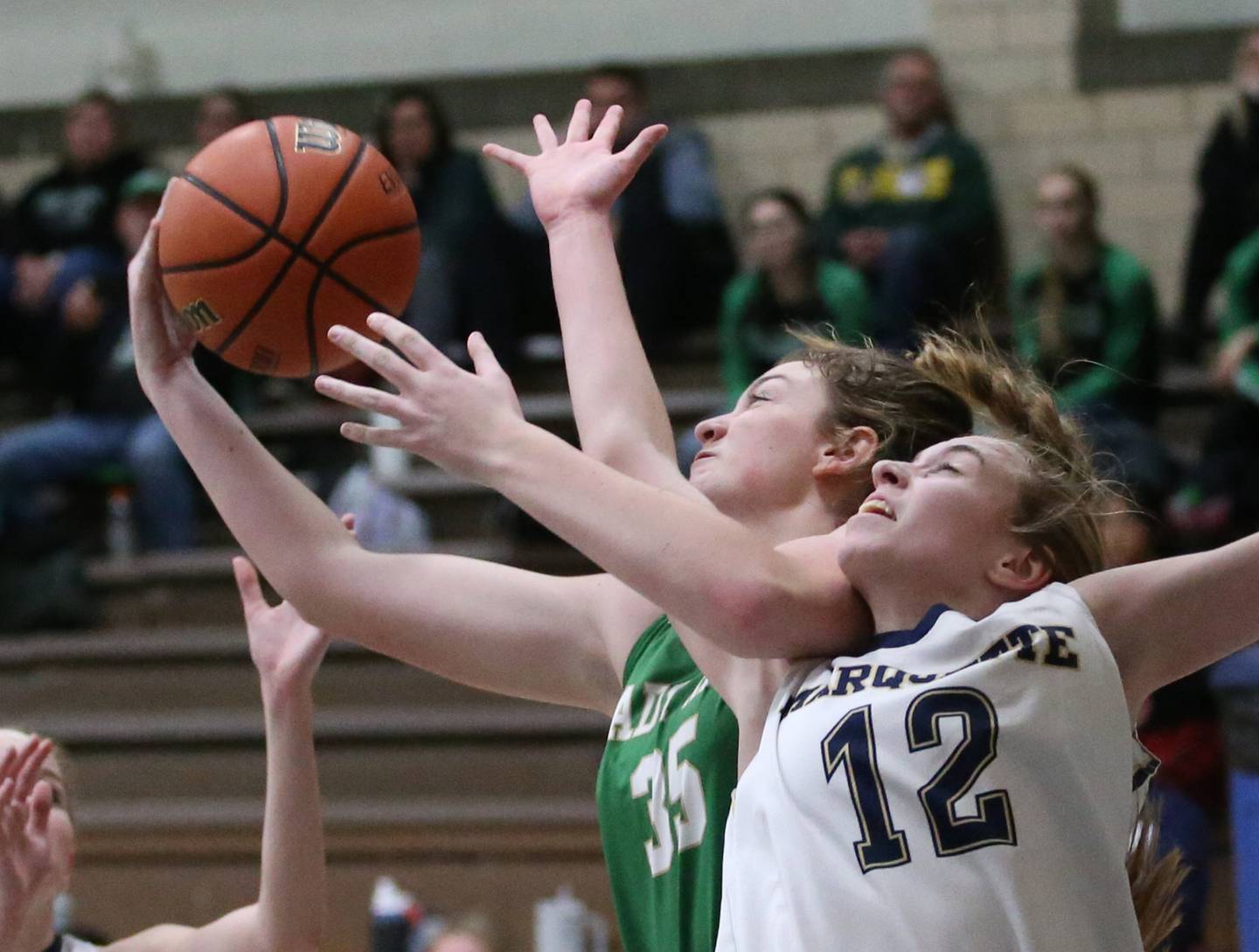 Seneca's Tessa Krull and Marquette's Lily Craig jump in the air to grab a rebound in Bader Gym on Monday, Jan. 23, 2023 at Marquette High School.