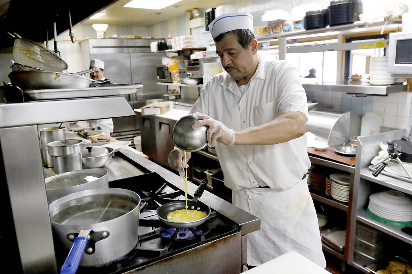Tony Loera makes an order of scrambled eggs on Friday, March 21, 2025, at Andy's Restaurant, in Crystal Lake.