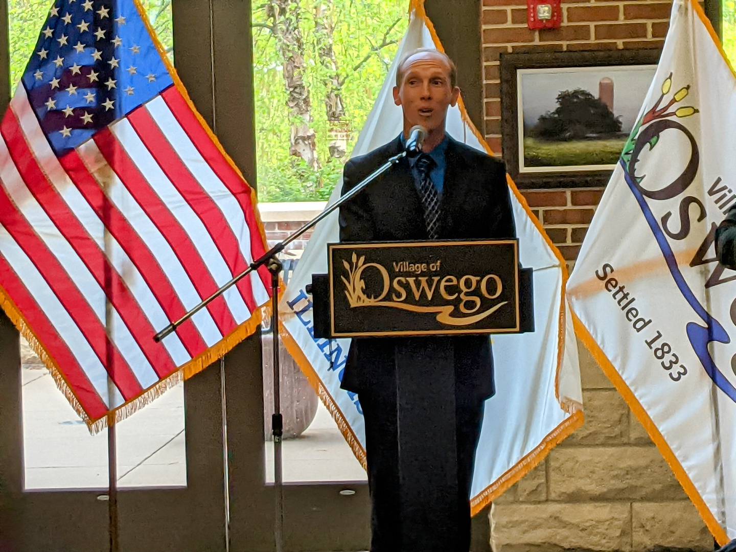 New Oswego Village Trustee James Cooper speaks to those gathered at a reception and swearing-in ceremony prior to the May 6 Village Board meeting.