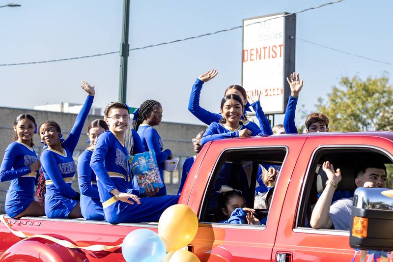 Joliet Central’s cheer team waves to spectators during the homecoming parade on Sept. 27. 2025.