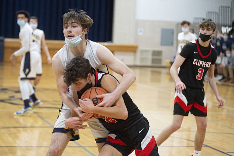 Polo's Brock Soltow and Amboy's Ian Eller wrestle for a loose ball on Wednesday, Jan. 26, 2022.