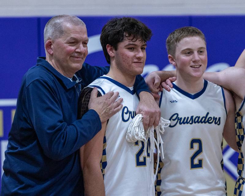 Marquette's Assistant Coach Jeff Herkelman, Matt Graham and Easton DeBernardi pose for photo after winning the Class 1A Regional Boys Basketball Championship game against St. Bede on Friday, Feb. 27, 2026 at Serena High School.