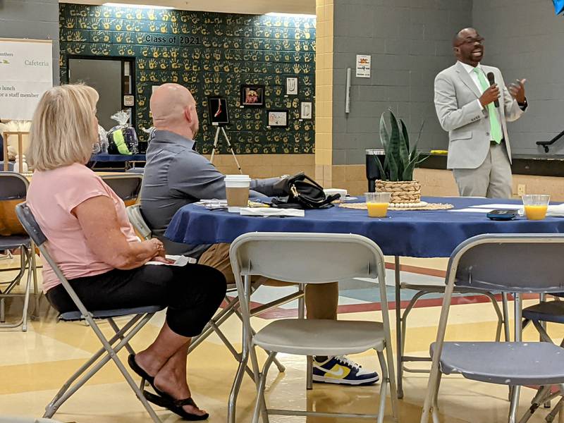 Oswego School District chief financial officer Raphael Obafemi speaks to those attending the second annual CommUNITY in Education Breakfast on June 3 at Traughber Junior High School.