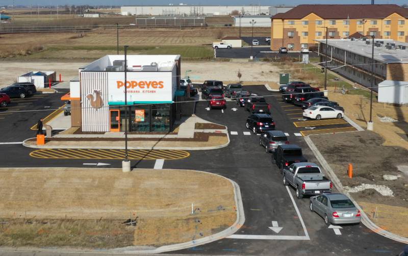 A long line of vehicles is backed up onto May Road for the opening of Popeyes on Monday, Dec. 9, 2024. The franchise opened their doors on Friday.