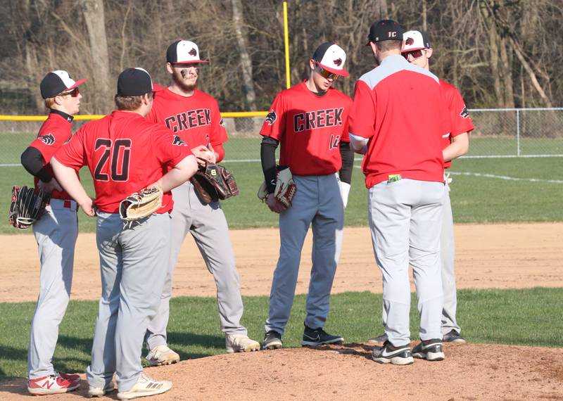Members of the Indian Creek baseball team gather on the mound while playing St. Bede on Thursday, March 28, 2024 at St. Bede Academy.