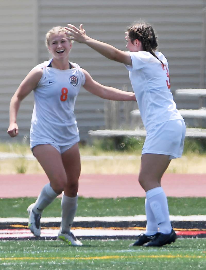 Crystal Lake Central’s Olivia Anderson laughs with teammate Katie Barth, right, after scoring against De La Salle in the IHSA girls Class 2A third-place soccer game at North Central College in Naperville on Saturday, June 3, 2023.