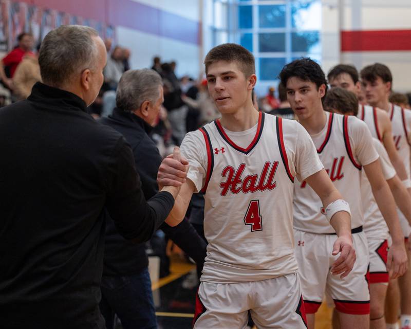 Hall's Luke Bryant (4) leads team in post-game high five line on Saturday, January 31, 2026 at Hall High School in Spring Valley.