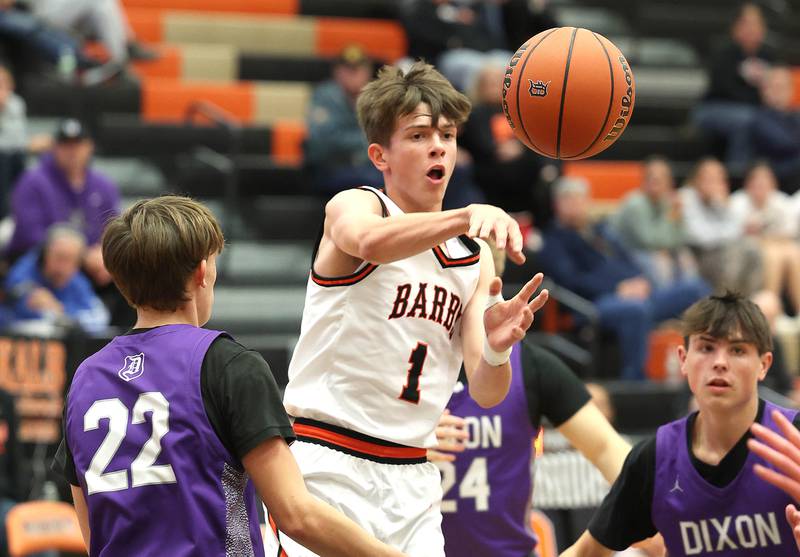 DeKalb’s Jackson Kees passes around Dixon’s Bryce Feit during their game Tuesday, Dec. 12, 2023, at DeKalb High School.