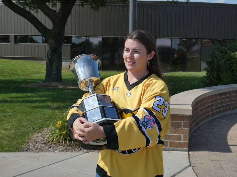 Professional hockey player Katelynn Russ, who grew up in Crystal Lake, proudly displays the Isobel Cup at Crystal Lake South High School Wednesday afternoon, Aug. 24, 2022, after being part of the championship-winning Boston Pride squad this past season.