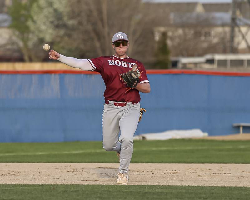 Plainfield North's Ron Palermo (14) throws to first to record the final out in their baseball game between Plainfield North at Oswego, Thursday, April 24, 2025 in Oswego.