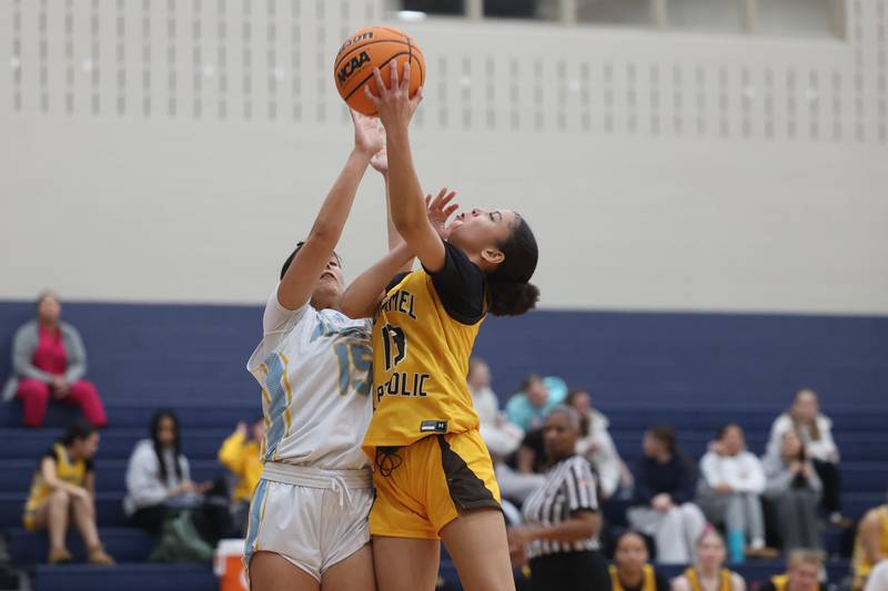 Carmel’s Maliyah Mays lays in a contested shot against Joliet Catholic on Wednesday, Jan 15, 2025 in Joliet.
