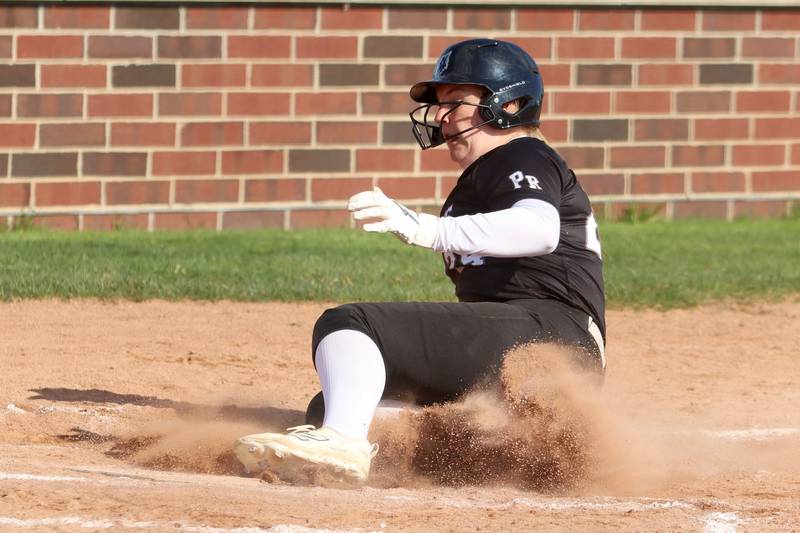 Prairie Ridge’s Reese Vrba slides safely into home  in varsity softball at Huntley High School in Huntley on Monday, May 5, 2025.