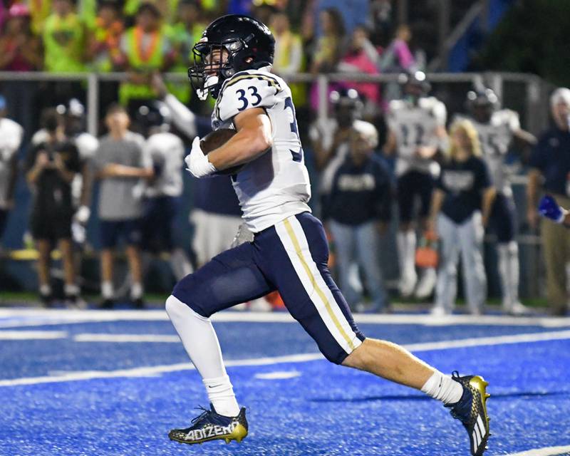 IC Catholic Prep Joey Glatta (33) runs the ball for 29 yards in the first quarter while traveling to take on St. Francis in Wheaton on Friday Sep. 29, 2023.