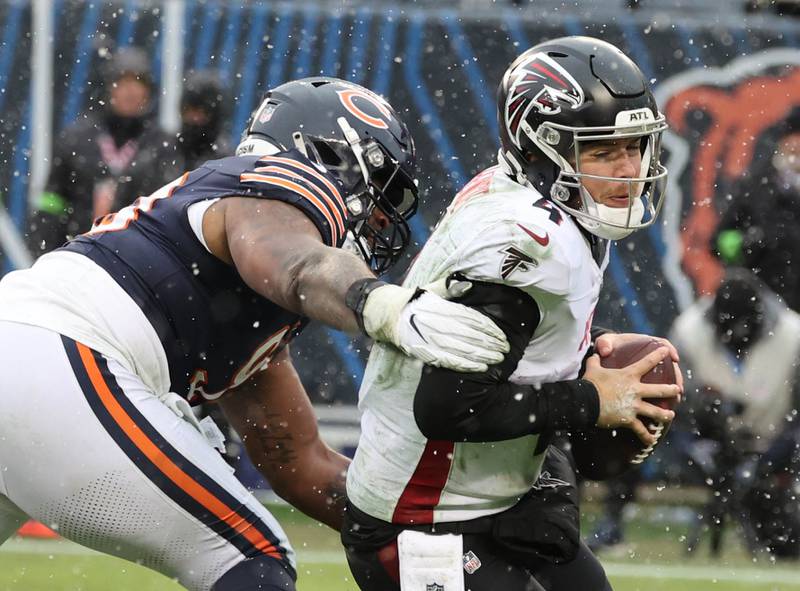 Chicago Bears defensive tackle Justin Jones pressures Atlanta Falcons quarterback Taylor Heinicke during their game Sunday, Dec. 31, 2023, at Soldier Field in Chicago.