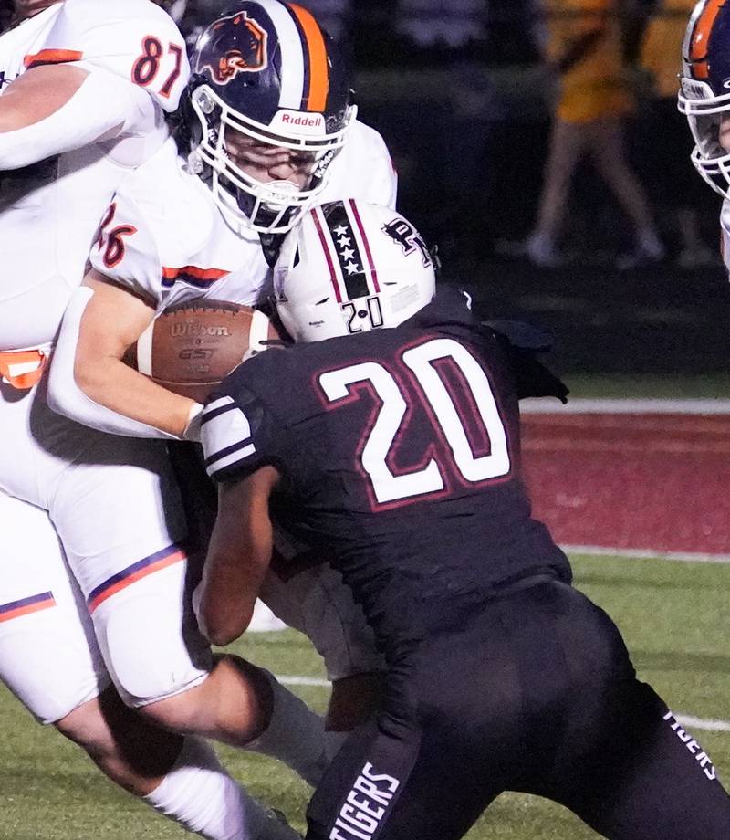 Plainfield North's Daniel Lee (20) hits Oswego’s Noah Vera (26) in the backfield for a loss during a football game at Plainfield North High School on Friday, Sept. 22, 2023.