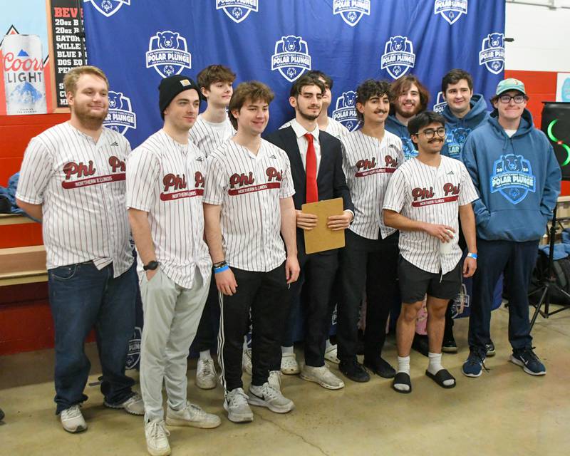 Members of the Phi Kappa Psi fraternity at NIU pose for a photo before the polar Plunge event on Saturday Feb. 21, 2026, held at Huskie Stadium in DeKalb.