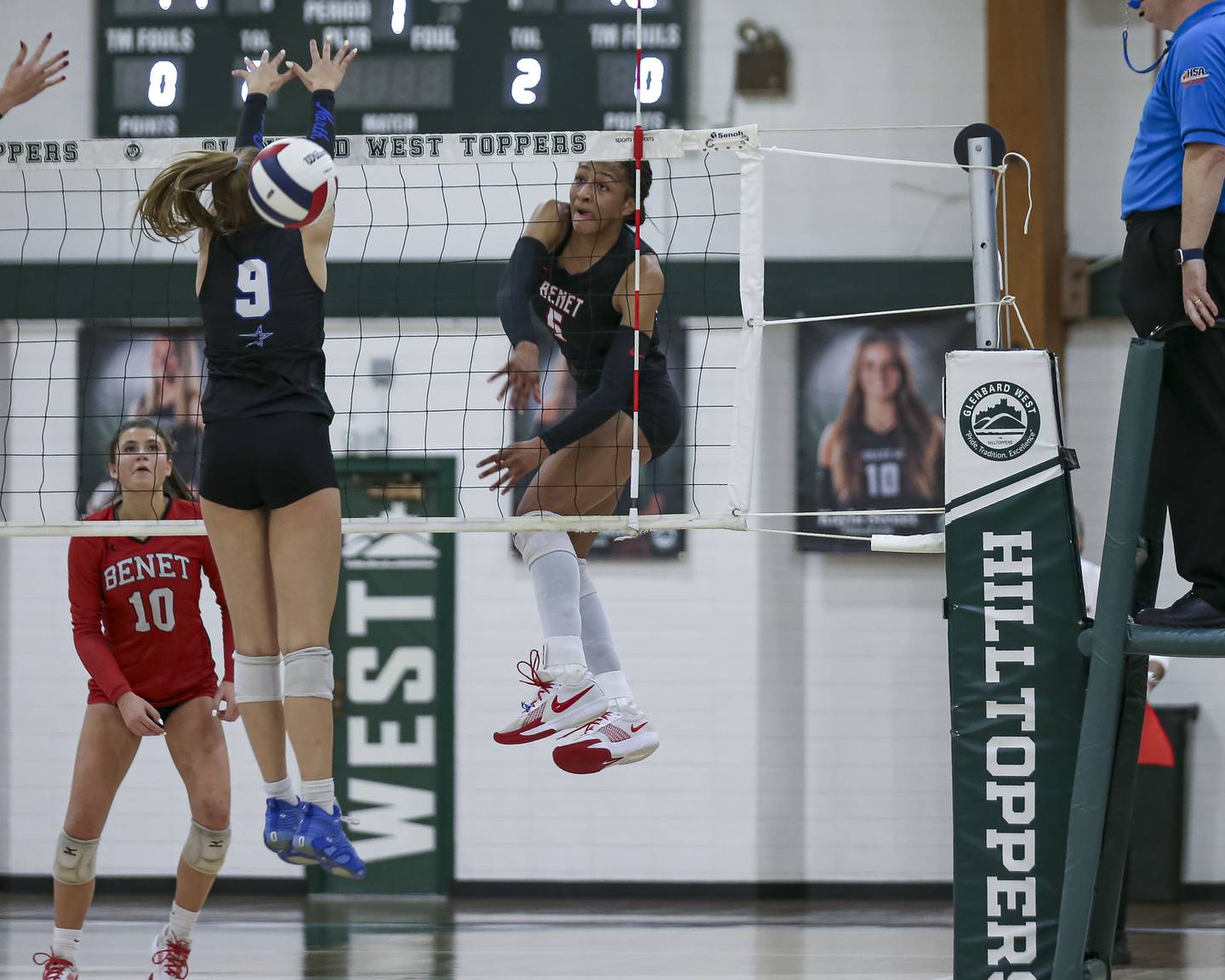 Benet's Brooklynne Brass (5) smashes a kill past St Charles North's Ellie Sutter (9) during Class 4A Glenbard West Sectional final volleyball match between St Charles North at Benet. Nov 6, 2025 in Glen Ellyn.
