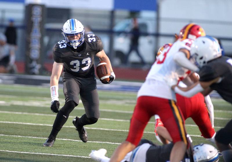 St. Charles North’s Jake Furtney carries the ball during a home game against Batavia on Friday, Sept. 15, 2023.
