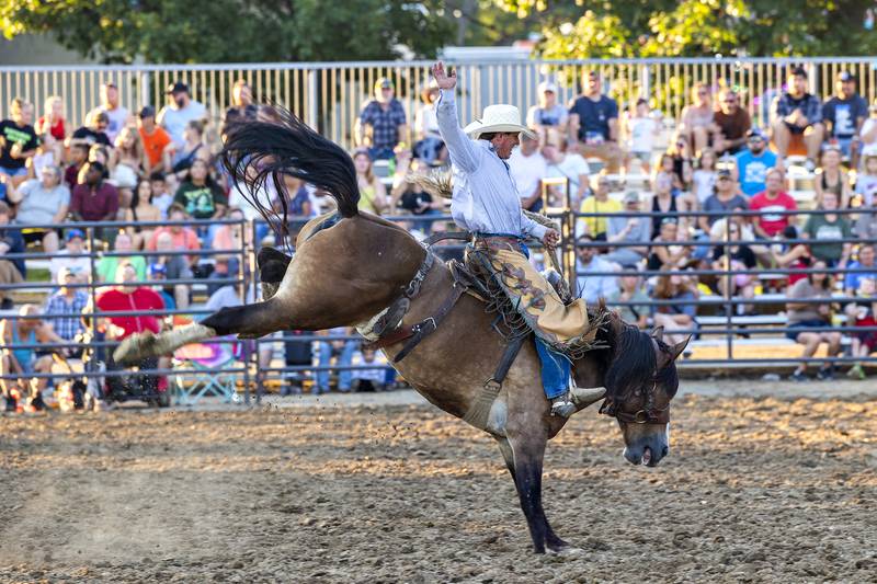 Kenneth Glick goes the full 8 seconds to start the show Wednesday, August 13, 2025, at the Whiteside County Fair during the Next Level Pro Bronc rodeo.