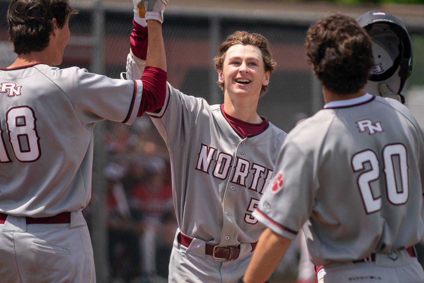 Plainfield North's Ryan Nelson (5) is greeted at home plate after hitting a two run homer against Yorkville during the Class 4A Yorkville Regional baseball final at Yorkville High School on Saturday, May 28, 2022.