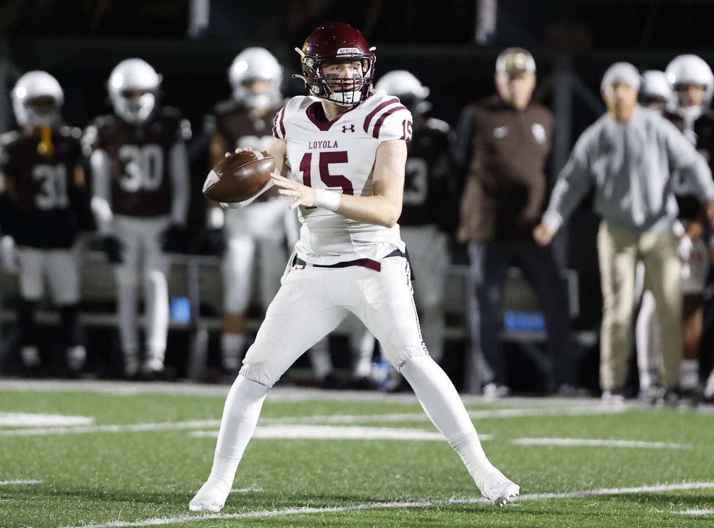 Loyola's Ryan Fitzgerald (15) looks for a receiver during the varsity football game between Loyola Academy and Mt. Carmel high school on Friday, Oct. 25, 2024 in Chicago.