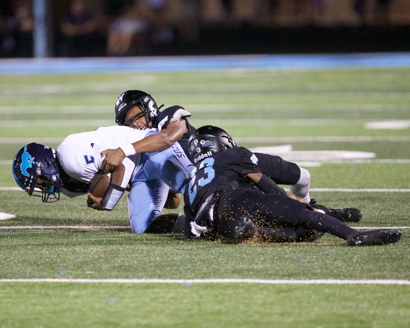 Downers Grove South's Kayden Smith is tailed by Willowbrook's Jeff Baker (23) on Friday, Sept. 20, 2024 in Villa Park.