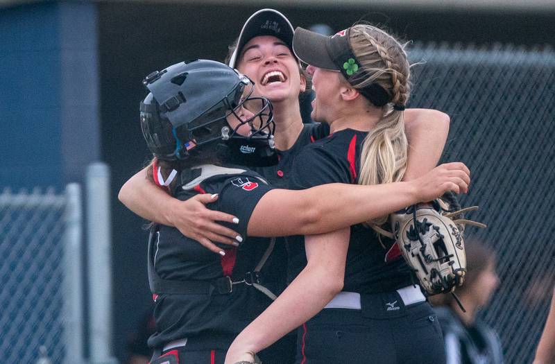 (Left to Right) Yorkville's Kaitlyn Roberts (8), Katlyn Schraeder (12) and Madi Reeves (2) celebrate after defeating Plainfield North to win the Class 4A Oswego East Regional softball championship at Oswego East High School on Friday, May 27, 2022.