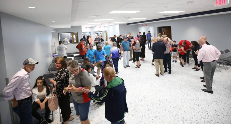 Visitors walk through the new Lighted Way building during the ribbon cutting and dedication on Saturday, Aug. 5, 2023 in La Salle.