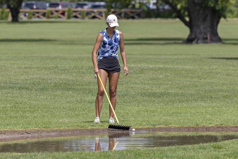 Ava Hackman of Sunset fishes her ball from a water laden sand trap Friday, July 11, 2025, during the 102nd annual Ladies Lincoln Highway golf tournament at Timber Creek Golf Club in Dixon.