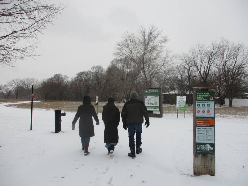 Three people head for a hike on a snowy trail in the Rock Run Preserve in Joliet on Wednesday. Feb. 12, 2025.