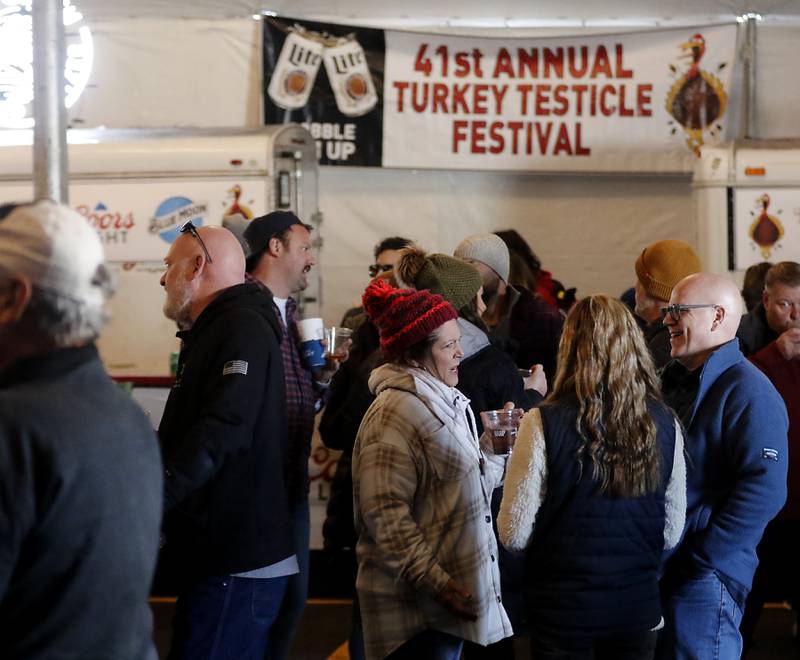 People socialize on Wednesday afternoon, Nov. 22, 2023, during the 41st annual Turkey Testicle Festival at Parkside Pub, in Huntley. The pre-Thanksgiving festival featured live music, beer, and lots of deep-fried turkey testicles.
