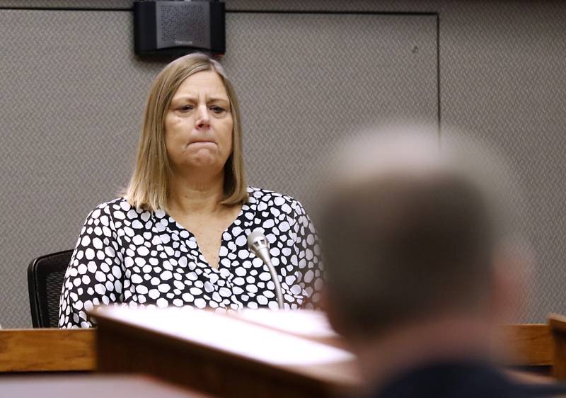Jeanne Berge listens to her 911 call about a May 2020 crash near Hebron that killed 41-year-old Jason Miller of McHenry, as she testifies Monday, Oct. 17, 2022, during the William Bishop’s bench trial before McHenry County Judge Michael Coppedge in the McHenry County courthouse in Woodstock.