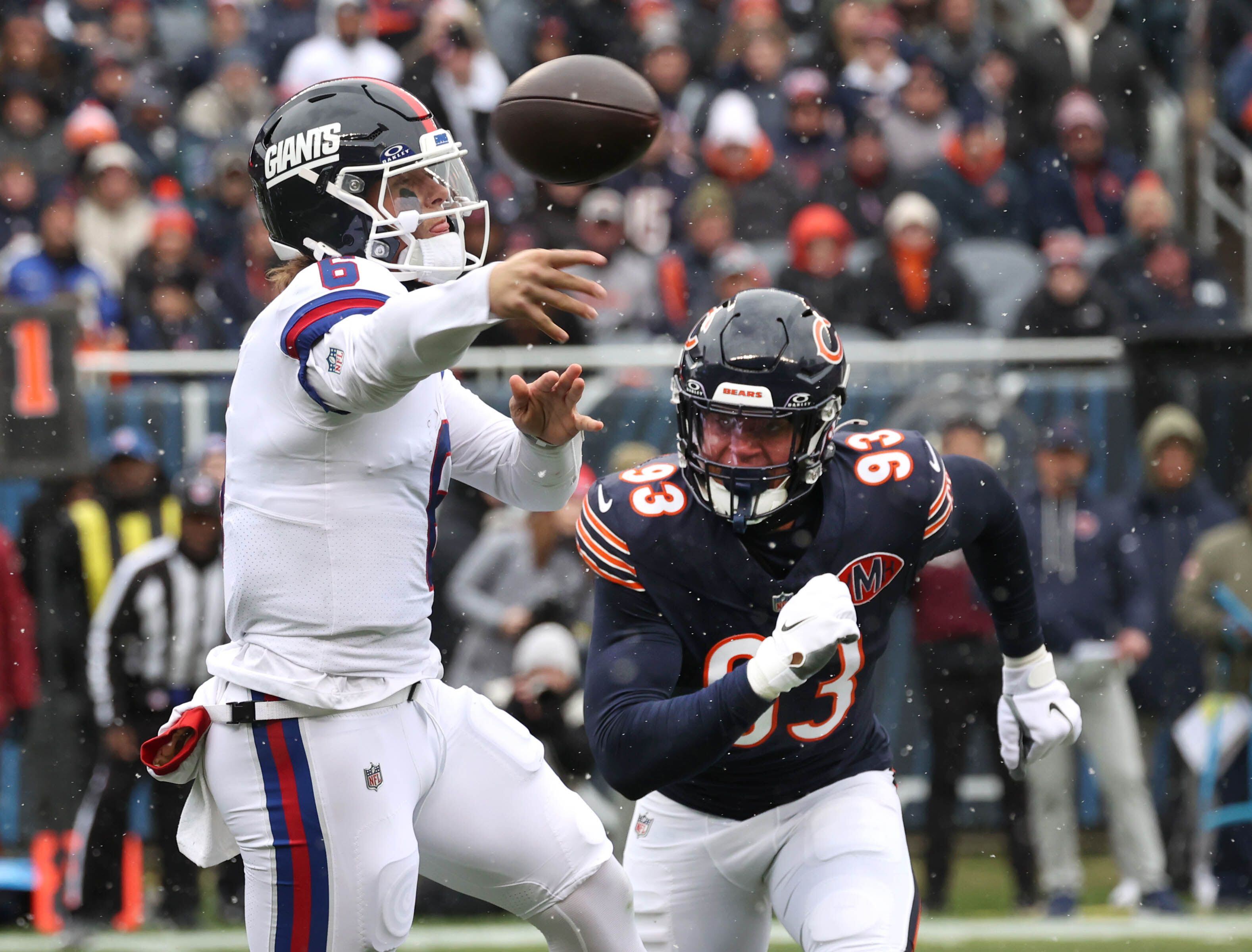 New York Giants quarterback Jaxson Dart gets rid of the ball just ahead of the pressure of Chicago Bears defensive end Joe Tryon-Shoyinka Sunday, Nov. 9, 2025, during their game at Soldier Field in Chicago.