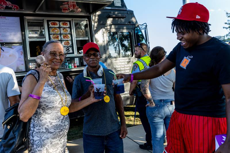 Nancy Dent, Alvis Saulsbury, and Jermaine Dunne cheers with their Hurricanes during New Orleans North Festival at Joliet Slammers Stadium on Aug. 15, 2025.