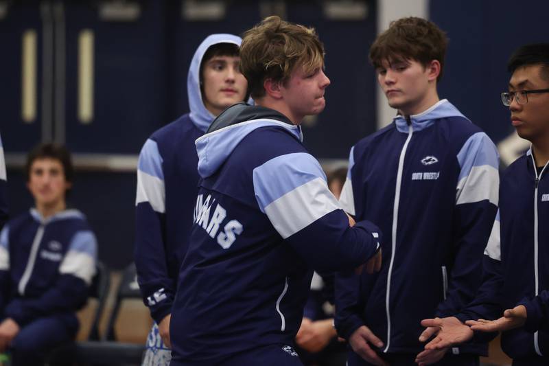 Plainfield South’s Matt Janiak greets teammates during player introductions before the match against Plainfield North in a Southwest Prairie dual meet on Wednesday, Nov. 29, 2023 in Plainfield.