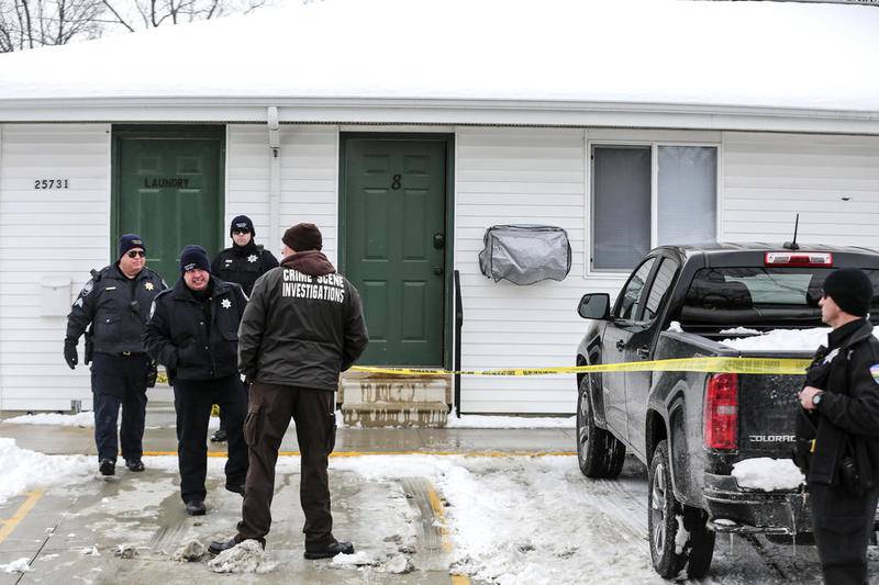 Investigators search through an apartment Tuesday, Feb. 13, 2018, after a body was discovered in Channahon, Ill.