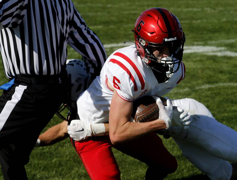 Huntley's Jake Witt fights through the tackle attempt of Cary-Grove's PJ Weaver to score a two-point conversion to win a Fox Valley Conference football game on Saturday, Oct. 7, 2023, at Cary-Grove High School.