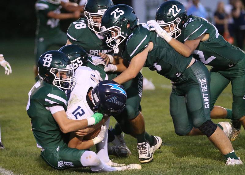 Bureau Valley's Brandon Carrington is brought down by St. Bede players (from left) Chase Riva, Burris Brody, Brennen Hirst and Max Moreno on Friday Aug. 29, 2025 at St. Bede Academy.