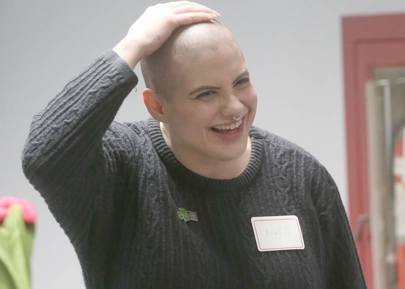 Avriel Miers touches her head after shaving it during the first-ever St. Baldrick's event on Wednesday, April 30, 2025 at Illinois Valley Community College.