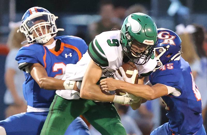 Genoa-Kingston's Traven Atterberry (left) and Maddox Lavender strip the ball from North Boone's Brandon Becker which results in a fumble and a defensive touchdown for the Cogs during their game Friday, Sept. 9, 2022, at Genoa-Kingston High School.