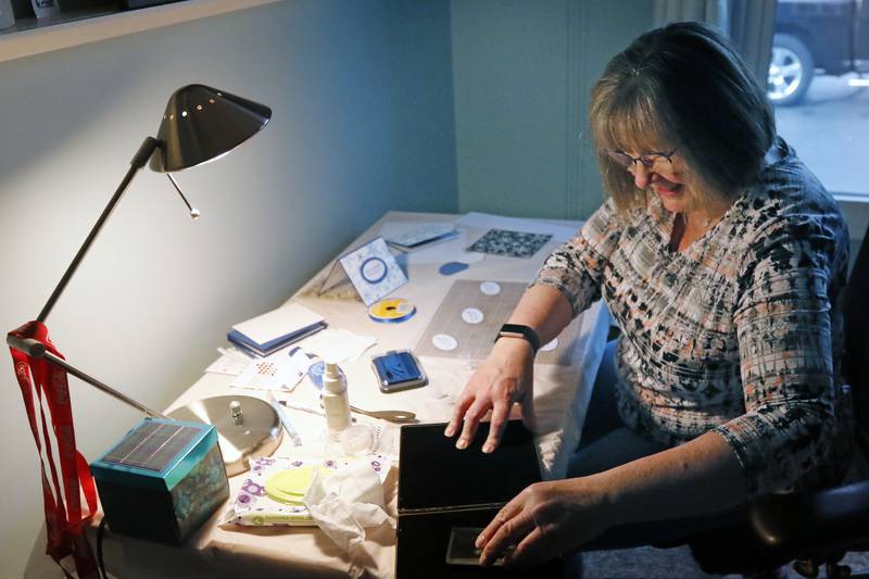 Diane Raycraft, of Crystal Lake, works on creating a handmade Christmas card for senior residents of Hearthstone on Friday, Dec. 10, 2021, in Crystal Lake.  Raycraft makes cards every month for seniors at the residence.