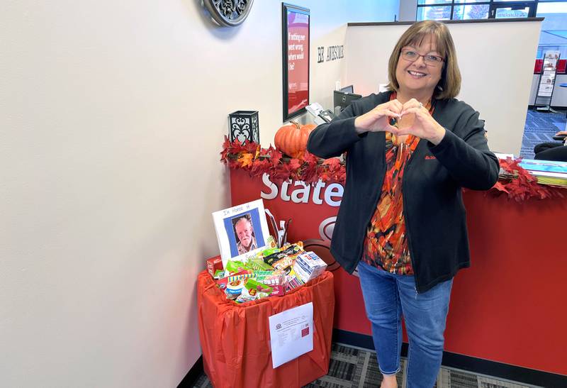 Sycamore-based State Farm agent Tina Hurst on Oct. 11, 2024 stands next to fill drop-box, and memorial to her uncle, a U.S. Army veteran of the Korean War. In October, she collaborated with Chicagoland Blue Star Mothers to send supplies to deployed members of the United States military.