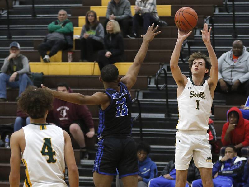 Crystal Lake South's Zachary Peltz shoots a three-pointer over Larkin’s Parnell Wilder during a Hinkle Holiday Classic basketball game Wednesday, Dec. 28, 2022, at Jacobs High School in Algonquin.